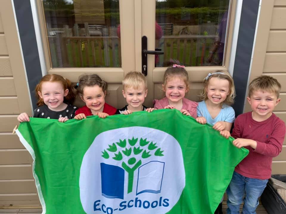 Wise Owls - Children holding Eco-Schools Green Flag